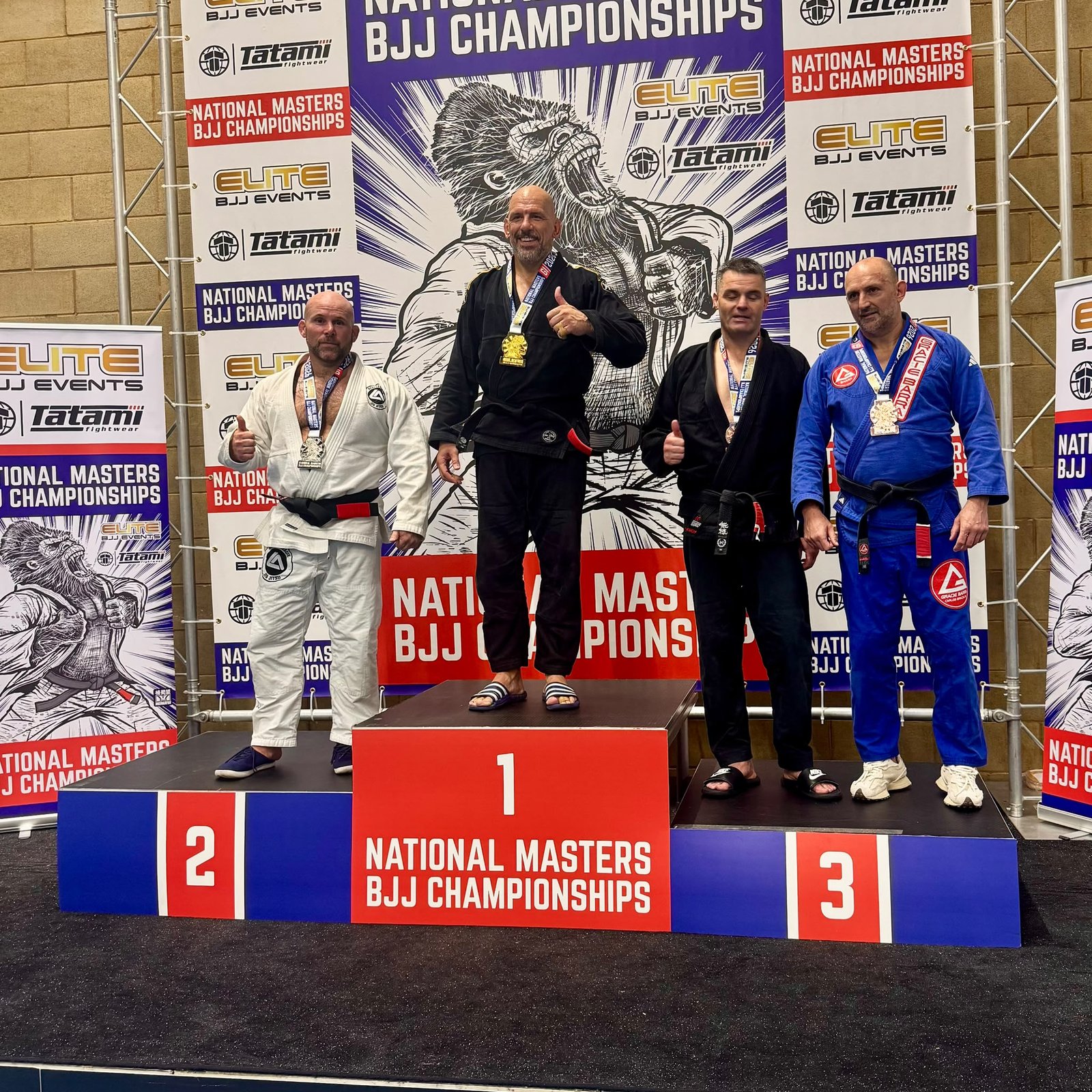 Sensei Ben receiving a silver medal on the podium at the National Masters BJJ Championships